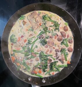 Curry simmering in a cast iron pan.